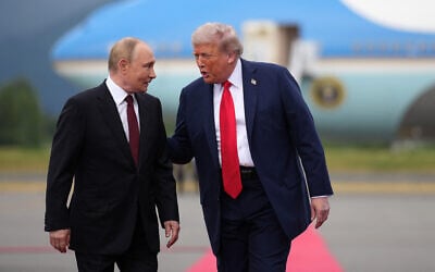 US President Donald Trump (R) walks with Russian President Vladimir Putin as they arrive at Joint Base Elmendorf-Richardson in Anchorage, Alaska, on August 15, 2025. (Andrew Harnik/ Getty Images/ AFP)