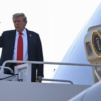 US President Donald Trump waves as he boards Air Force One as he departs Joint Base Andrews in Maryland on August 15, 2025, en route to Anchorage for a summit with his Russian counterpart Vladimir Putin (Photo by ANDREW CABALLERO-REYNOLDS / AFP)