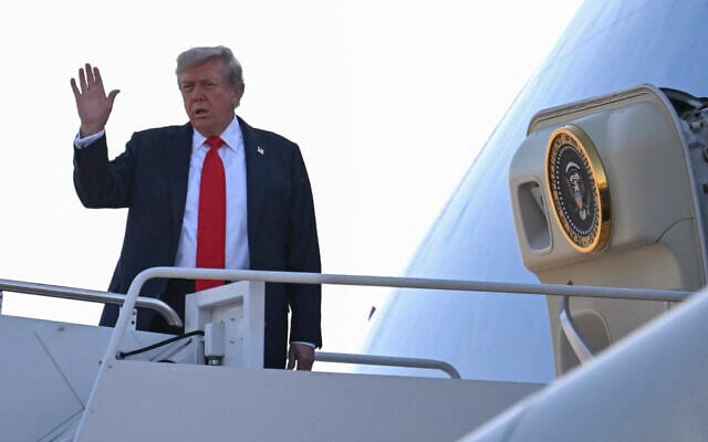 US President Donald Trump waves as he boards Air Force One as he departs Joint Base Andrews in Maryland on August 15, 2025, en route to Anchorage for a summit with his Russian counterpart Vladimir Putin (Photo by ANDREW CABALLERO-REYNOLDS / AFP)