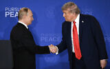 US President Donald Trump (R) and Russian President Vladimir Putin shake hands at the end of a joint press conference after participating in a US-Russia summit on Ukraine at Joint Base Elmendorf-Richardson in Anchorage, Alaska, on August 15, 2025. (Drew Angerer/AFP)