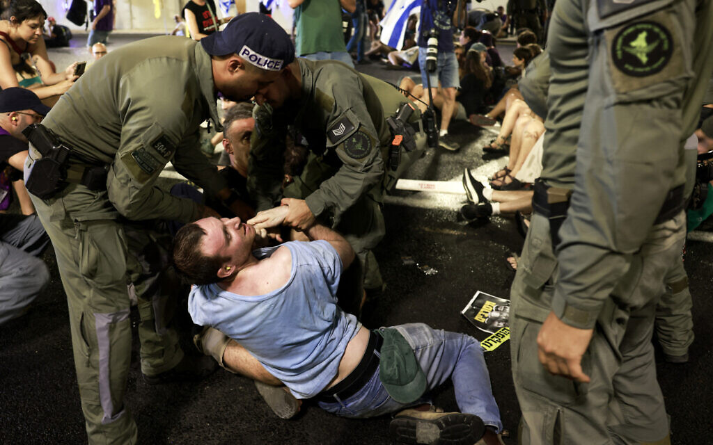Israeli police remove demonstrators blocking traffic in a tunnel, as families and supporters of Israelis held hostage by Hamas terrorists in Gaza since the October 7, 2023 attack stage a protest calling for government action to secure their release in Jerusalem on August 17, 2025. (Menahem Kahana / AFP)