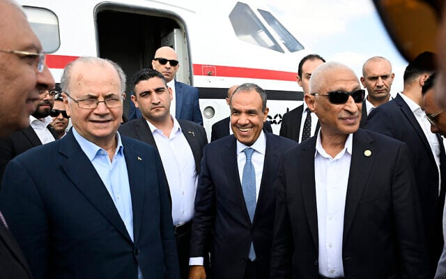Palestinian Authority Prime Minister Mohammad Mustafa (L), accompanied by Egypt's Foreign Minister Badr Abdelatty (C), arrives at an airport in El-Arish, Egypt, on August 18, 2025. (Khaled DESOUKI / AFP)
