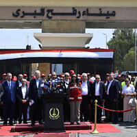 Palestinian Authority Prime Minister Mohammad Mustafa (C-L) listens as Egypt's Foreign Minister Badr Abdelatty (C) speaks at a press conference on the Egyptian side of the Rafah border crossing in Rafah on August 18, 2025.  (Photo by Khaled DESOUKI / AFP)