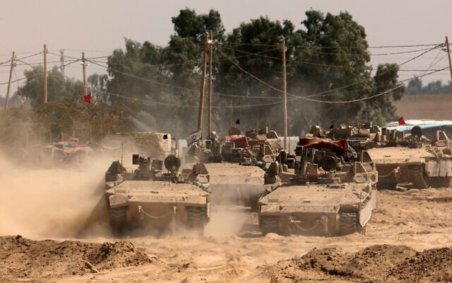 This picture taken from a position at Israel's border with the Gaza Strip shows Israeli troops deployed in the area on August 19, 2025 (Photo by Jack GUEZ / AFP)