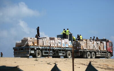 A truck transporting humanitarian aid drives down a road in Deir al-Balah in the central Gaza Strip on August 21, 2025. (Eyad Baba/AFP)