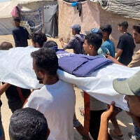 Mourners carry the body of one of five journalists killed in an Israeli strike on Nasser hospital in Khan Yunis in the southern Gaza Strip, during their funeral on August 25, 2025.  (Photo by AFP)