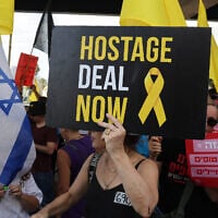 Protesters gather with signs and Israeli flags during a demonstration in Tel Aviv on August 26, 2025. (Jack GUEZ / AFP)