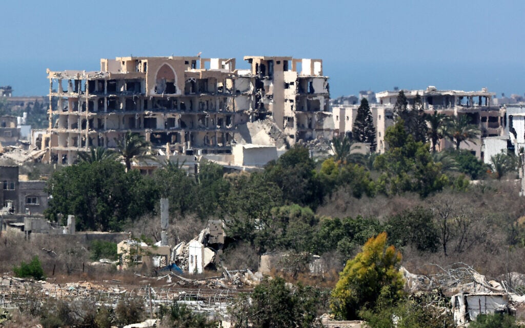This picture taken from a position on the Israeli border with the Gaza Strip shows destroyed buildings in the embattled territory on August 27, 2025. (Jack GUEZ / AFP)