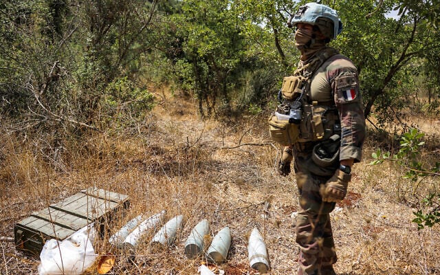 A French peacekeeper of the United Nations Interim Force in Lebanon (UNIFIL) stands by munitions formerly used by Iran-backed Hezbollah at a position that was held by the group in the Khraibeh Valley in el-Meri in south Lebanon on August 27, 2025. (ANWAR AMRO / AFP) A French peacekeeper of the United Nations Interim Force in Lebanon (UNIFIL) stands by munitions formerly used by Iran-backed Hezbollah at a position that was held by the group in the Khraibeh Valley in el-Meri in south Lebanon on August 27, 2025. (ANWAR AMRO / AFP)