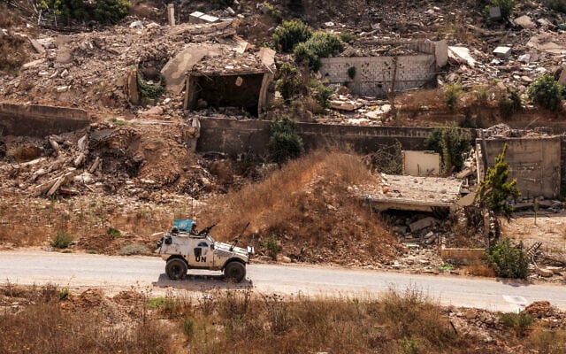 An armored vehicle of the United Nations Interim Force in Lebanon (UNIFIL) moves past destroyed buildings along a road in the village of Kfar Kila in southern Lebanon near the border with northern Israel on August 27, 2025. (ANWAR AMRO / AFP)
