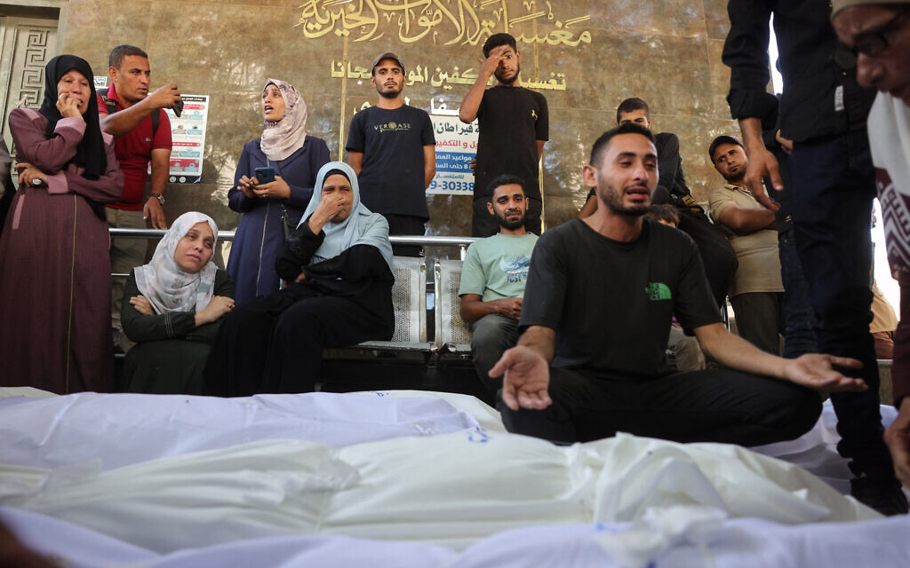 Graphic content / Palestinians mourn outside Shifa hospital in Gaza City where casualties of Israeli fire were transported ahead of their funerals, on August 29, 2025. (Photo by BASHAR TALEB / AFP)
