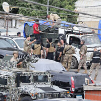 Lebanese army soldiers load boxes of weapons handed over by Palestinian groups onto trucks at the Burj al-Barajneh camp in Beirut's southern suburbs on August 29, 2025. (ANWAR AMRO / AFP)