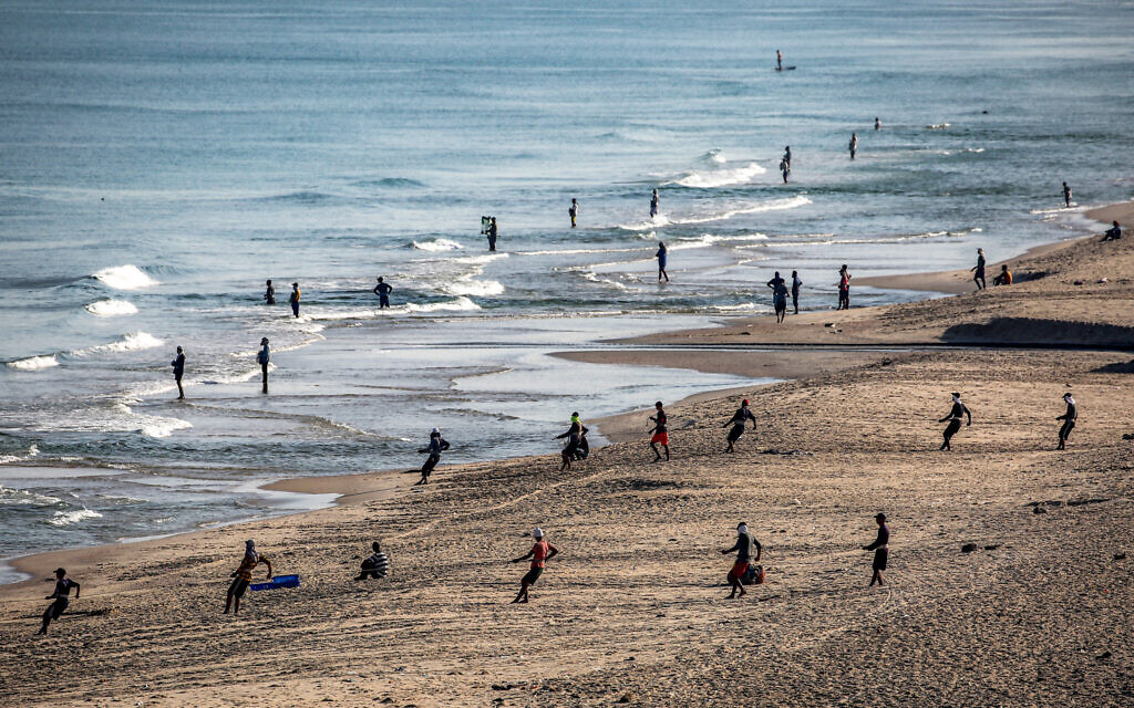 Fishermen pull their nets to retrieve their catch on a beach in Nuseirat in the central Gaza Strip on August 30, 2025.  (Photo by Eyad BABA / AFP)