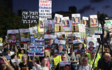 Protesters lift placards during a demonstration organized by the families of hostages held in Gaza, in Tel Aviv on August 30, 2025. (Jack GUEZ / AFP)