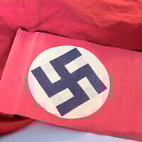 Illustrative: A swastika flag displayed in a showcase during the press preview at the new permanent exhibition of former Nazi concentration camp Buchenwald near Weimar, Germany, April 13, 2016.(AP Photo/Jens Meyer)