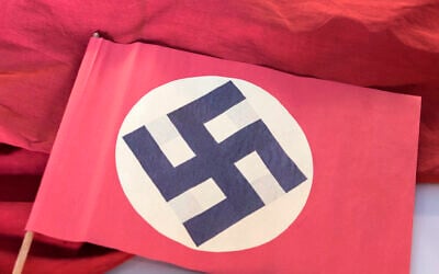 Illustrative: A swastika flag displayed in a showcase during the press preview at the new permanent exhibition of former Nazi concentration camp Buchenwald near Weimar, Germany, April 13, 2016.(AP Photo/Jens Meyer)