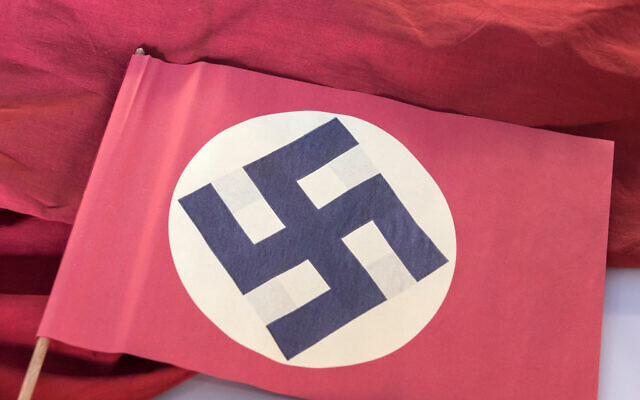 Illustrative: A swastika flag displayed in a showcase during the press preview at the new permanent exhibition of former Nazi concentration camp Buchenwald near Weimar, Germany, April 13, 2016.(AP Photo/Jens Meyer) Illustrative: A swastika flag displayed in a showcase during the press preview at the new permanent exhibition of former Nazi concentration camp Buchenwald near Weimar, Germany, April 13, 2016.(AP Photo/Jens Meyer)