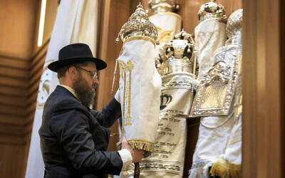 Illustrative: Rabbi Yehuda Teichtal prepares Torah scrolls at the synagogue of the Chabad community in Berlin, Germany, Friday, October 13, 2023. (AP Photo/Markus Schreiber) Illustrative: Rabbi Yehuda Teichtal prepares Torah scrolls at the synagogue of the Chabad community in Berlin, Germany, Friday, October 13, 2023. (AP Photo/Markus Schreiber)