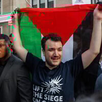 Anti-Israel, pro-Palestinian US activist Mahmoud Khalil carries a Palestinian flag during a rally celebrating his return from immigration detention, June 22, 2025, in New York. (AP Photo/Olga Fedorova)