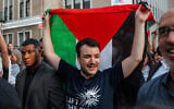 Anti-Israel, pro-Palestinian US activist Mahmoud Khalil carries a Palestinian flag during a rally celebrating his return from immigration detention, June 22, 2025, in New York. (AP Photo/Olga Fedorova)