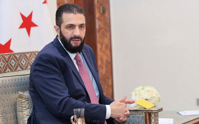 In this photo released by the Syrian official news agency SANA, Syria's President Ahmad al-Sharaa receives the final version of the provisional electoral system for the people's assembly, in Damascus, Syria, July 27, 2025. (SANA via AP) In this photo released by the Syrian official news agency SANA, Syria's President Ahmad al-Sharaa receives the final version of the provisional electoral system for the people's assembly, in Damascus, Syria, July 27, 2025. (SANA via AP)