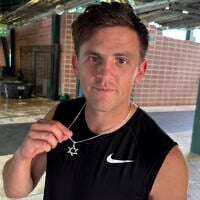 New Tulane quarterback Jake Retzlaff, a transfer from Brigham Young University, shows off the Star of David on his necklace after football practice at Yulman Stadium in New Orleans, on Friday, Aug. 1, 2025. (AP Photo/Brett Martel)