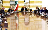 In this photo released by the Lebanese Presidency press office, Lebanese president Joseph Aoun, centre, and Lebanese Prime Minister Nawaf Salam, left background, lead a Cabinet meeting to discuss the disarmament of Hezbollah, at the presidential palace in Baabda, east of Beirut, Lebanon, August 5, 2025. (Lebanese Presidency press office via AP)