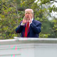 US President Donald Trump shouts to reporters as he surveys the grounds from the roof above the Colonnade that goes to the West Wing of the White House, August 5, 2025, in Washington. (AP Photo/Alex Brandon)