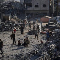 People inspect the damage at the Sheikh Radwan al-Taba UNRWA clinic, in Gaza City, August 6, 2025. (AP Photo/Jehad Alshrafi)