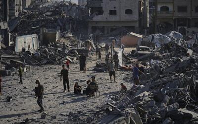 People inspect the damage at the Sheikh Radwan al-Taba UNRWA clinic, in Gaza City, August 6, 2025. (AP Photo/Jehad Alshrafi)