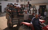 Palestinians carry the body of a person who was killed while trying to reach aid trucks entering northern Gaza Strip through the Zikim crossing with Israel, at Shifa Hospital in Gaza City, August 6, 2025. (Jehad Alshrafi/AP)
