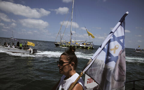 Relatives of Israeli hostages held by Hamas sail along the coast of Ashkelon on Thursday, August 7, 2025. (AP/Leo Correa)