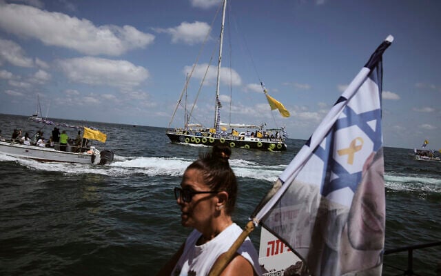 Relatives of Israeli hostages held by Hamas sail along the coast of Ashkelon on Thursday, August 7, 2025. (AP/Leo Correa)