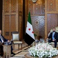 In this handout photo released by the Turkish Foreign Ministry press service, Turkish Foreign Minister Hakan Fidan, left, sits with Syria's interim President Ahmad Al-Sharaa, during their meeting in Damascus, Syria, on August 7, 2025. (Turkish Foreign Ministry via AP)