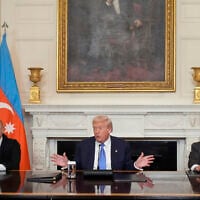 US President Donald Trump, center, Armenian Prime Minister Nikol Pashinyan, right, and Azerbaijani President Ilham Aliyev, at a trilateral signing ceremony in White House, August 8, 2025, in Washington. (AP/Mark Schiefelbein)