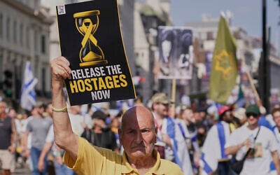 Illustrative: A man holds a placard up as he takes part in the March for Hostages in London, August 10, 2025. (AP Photo/Alberto Pezzali)