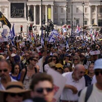Demonstrators hold placards as they take part in the March for Hostages, in London, August 10, 2025. (AP Photo/ Alberto Pezzali)