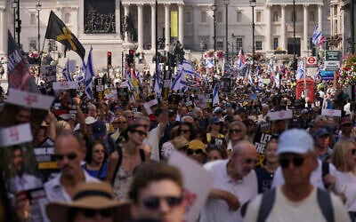 Demonstrators hold placards as they take part in the March for Hostages, in London, August 10, 2025. (AP Photo/ Alberto Pezzali)