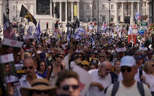 Demonstrators hold placards as they take part in the March for Hostages, in London, August 10, 2025. (AP Photo/ Alberto Pezzali)
