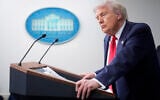 US President Donald Trump listens to a question from a reporter in the James Brady Press Briefing Room at the White House, Monday, Aug. 11, 2025, in Washington. (AP Photo/Mark Schiefelbein)