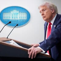 US President Donald Trump listens to a question from a reporter in the James Brady Press Briefing Room at the White House, Monday, Aug. 11, 2025, in Washington. (AP Photo/Mark Schiefelbein)