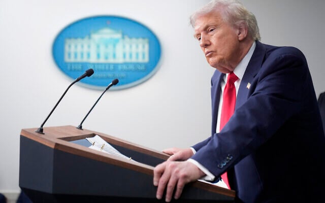 US President Donald Trump listens to a question from a reporter in the James Brady Press Briefing Room at the White House, Monday, Aug. 11, 2025, in Washington. (AP Photo/Mark Schiefelbein)