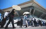 Guests on their way to attending a memorial service marking the 80th anniversary of Japan's World War II defeat, at the Nippon Budokan Hall Friday, August 15, 2025, in Tokyo. (AP/Eugene Hoshiko)