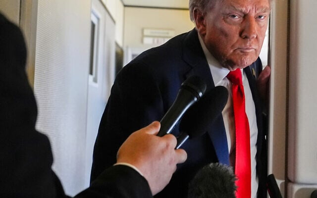 President Donald Trump speaks to reporters aboard Air Force One while en route to meet with Russia's President Vladimir Putin at Joint Base Elmendorf-Richardson, Alaska, Friday, Aug. 15, 2025. (AP Photo/Julia Demaree Nikhinson)