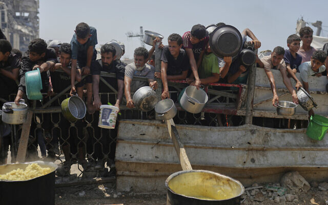Palestinians scramble for donated food at a community kitchen in Gaza City, northern Gaza Strip, Saturday, Aug. 16, 2025. (AP/Jehad Alshrafi) Palestinians scramble for donated food at a community kitchen in Gaza City, northern Gaza Strip, Saturday, Aug. 16, 2025. (AP/Jehad Alshrafi)
