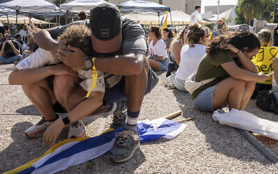 People sit on the ground and cover their heads as a sirens warn of an incoming missile fired from Yemen during a protest demanding the immediate release of hostages held by Hamas, in Tel Aviv, August. 17, 2025. (AP Photo/Maya Levin) People sit on the ground and cover their heads as a sirens warn of an incoming missile fired from Yemen during a protest demanding the immediate release of hostages held by Hamas, in Tel Aviv, August. 17, 2025. (AP Photo/Maya Levin)