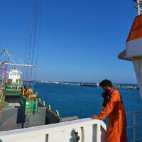 Jalal Uddin, electrical and technology officer aboard a Panamanian-flagged ship watches as containers filled with humanitarian aid for the people of Gaza are being loaded aboard the vessel at Cyprus' main port in Limassol, on August 18, 2025. (AP Photo/Petros Karadjias)