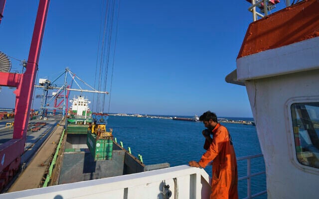 Jalal Uddin, electrical and technology officer aboard a Panamanian-flagged ship watches as containers filled with humanitarian aid for the people of Gaza are being loaded aboard the vessel at Cyprus' main port in Limassol, on August 18, 2025. (AP Photo/Petros Karadjias) Jalal Uddin, electrical and technology officer aboard a Panamanian-flagged ship watches as containers filled with humanitarian aid for the people of Gaza are being loaded aboard the vessel at Cyprus' main port in Limassol, on August 18, 2025. (AP Photo/Petros Karadjias)