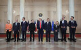 European Commission President Ursula von der Leyen, from left, British Prime Minister Keir Starmer, Finland President Alexander Stubb, Ukrainian President Volodymyr Zelenskyy, US President Donald Trump, France's President Emmanuel Macron, Italy's Prime Minister Giorgia Meloni, Germany's Chancellor Friedrich Merz and NATO Secretary General Mark Rutte stand before a group photo in the Grand Foyer of the White House on Monday, August 18, 2025, in Washington, DC. (AP Photo/Alex Brandon)