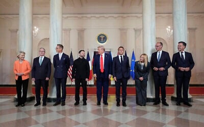 European Commission President Ursula von der Leyen, from left, British Prime Minister Keir Starmer, Finland President Alexander Stubb, Ukrainian President Volodymyr Zelenskyy, US President Donald Trump, France's President Emmanuel Macron, Italy's Prime Minister Giorgia Meloni, Germany's Chancellor Friedrich Merz and NATO Secretary General Mark Rutte stand before a group photo in the Grand Foyer of the White House on Monday, August 18, 2025, in Washington, DC. (AP Photo/Alex Brandon)